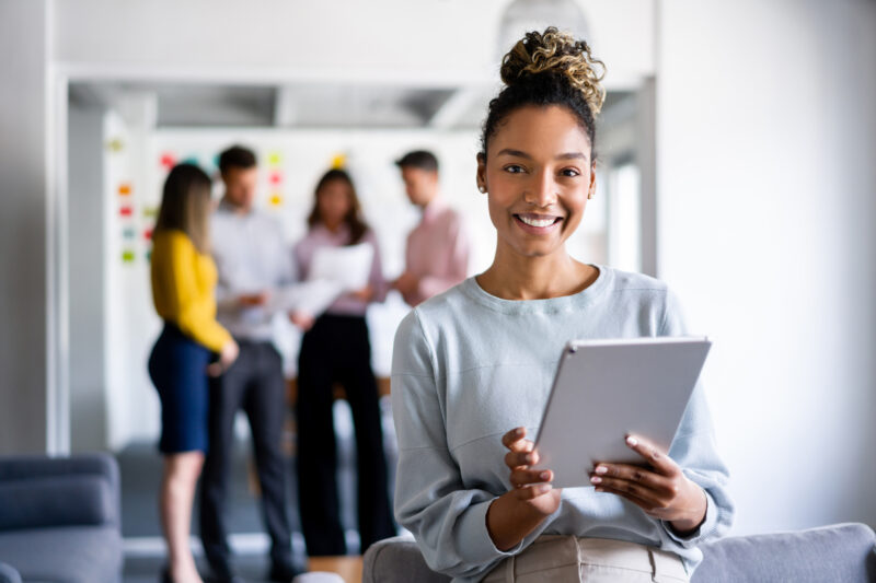 Portrait of an African American business woman working online at the office using a tablet computer