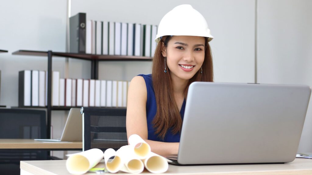 vietnamese construction estimator working in front of a laptop