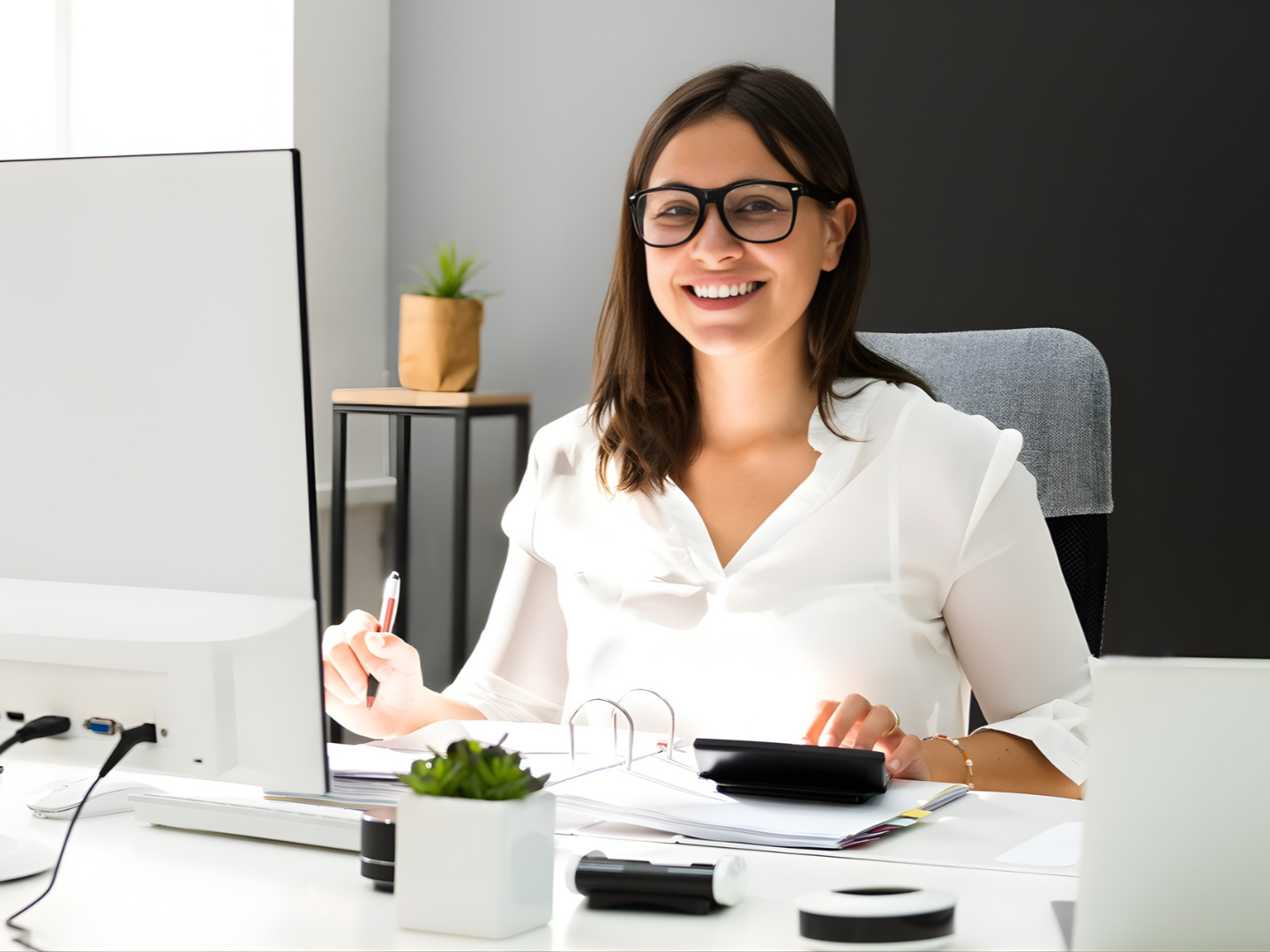 argentine offshore bookkeeper working in a bright office with calculator on desk