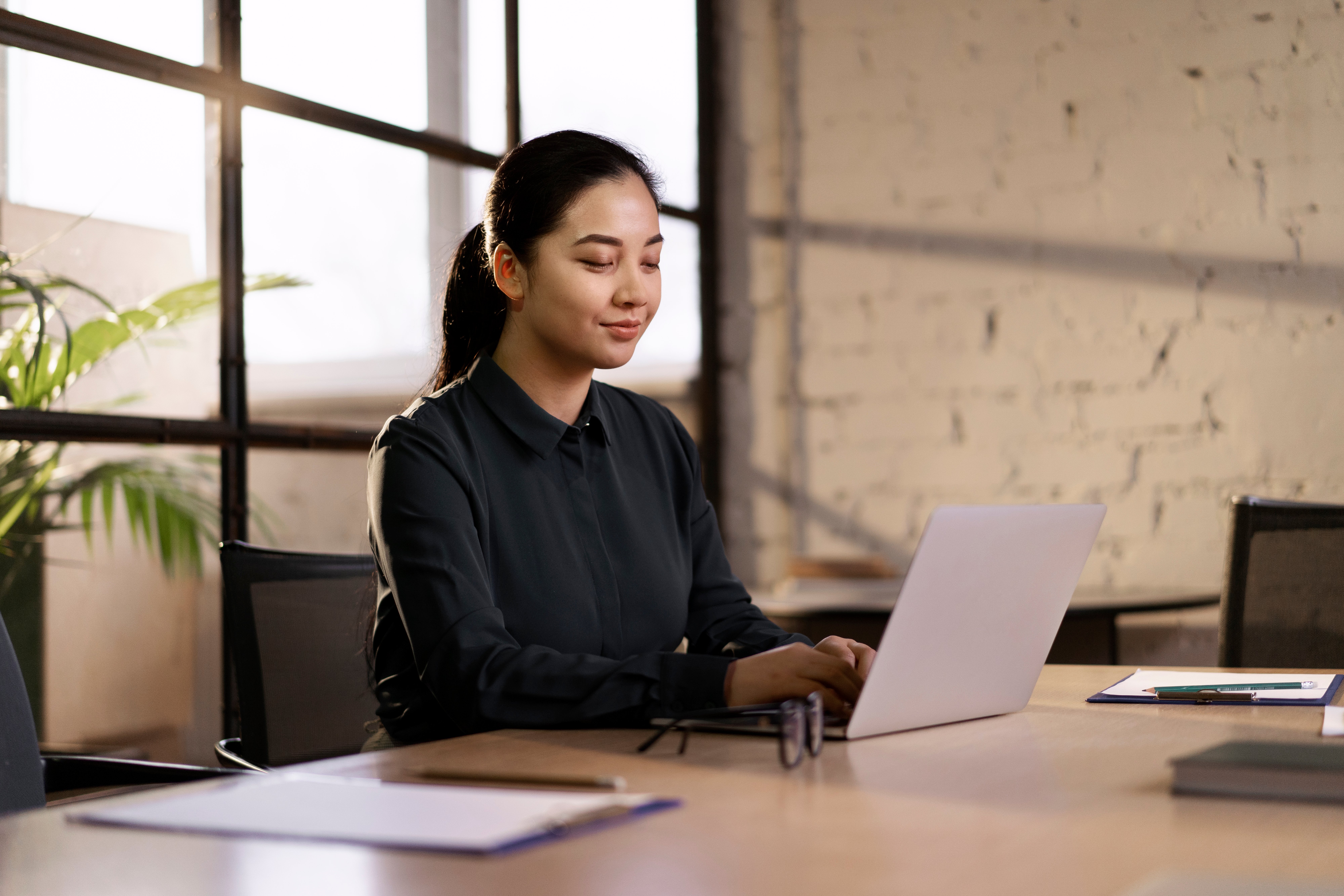 vietnamese offshore ai engineer programming in a laptop at a office desk