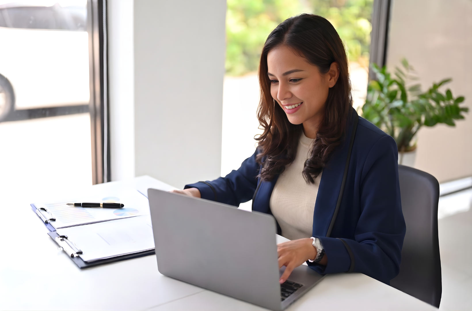 latina outsourced operations manager working with laptop