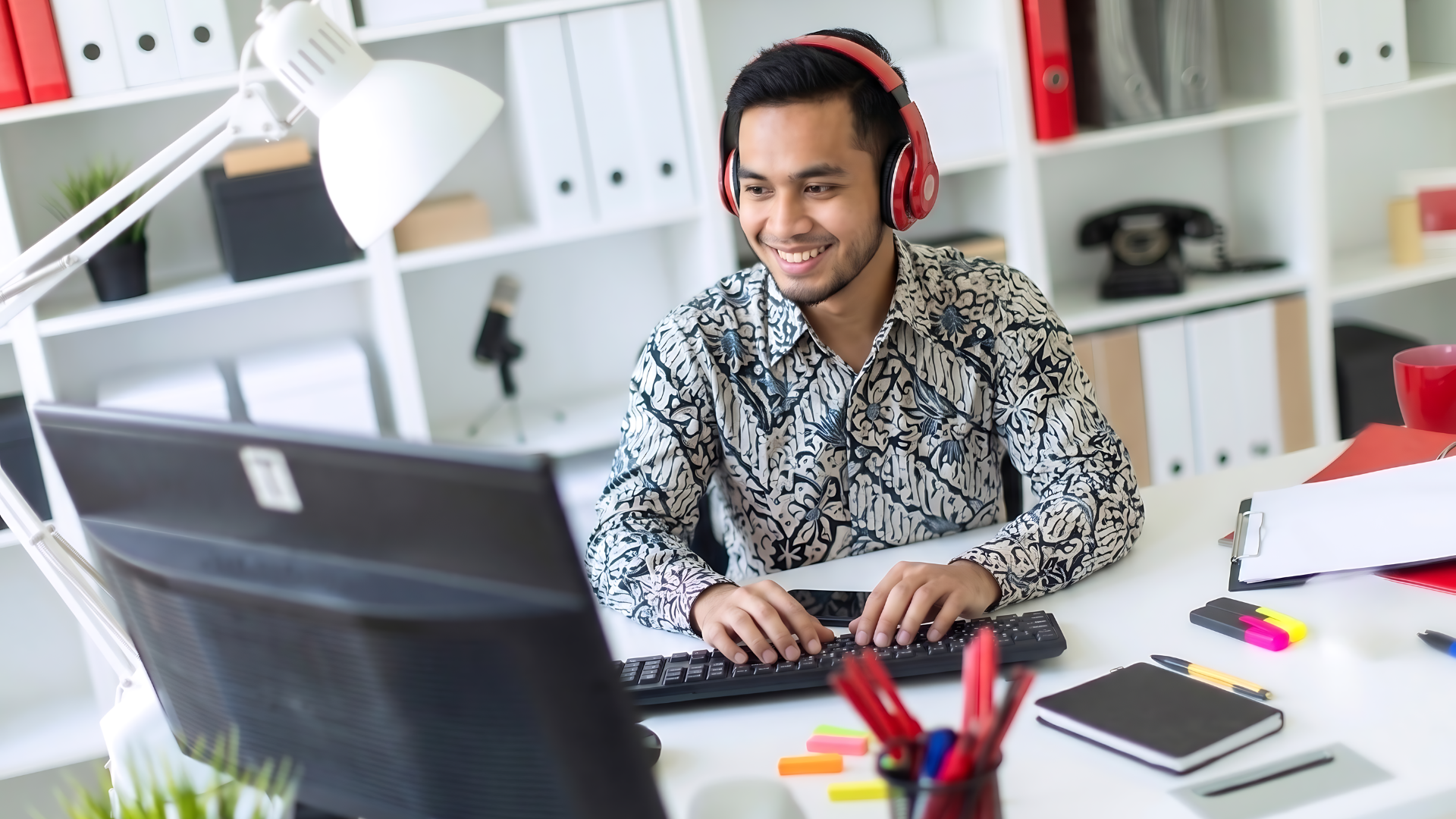 malaysian content producer working actively in an office