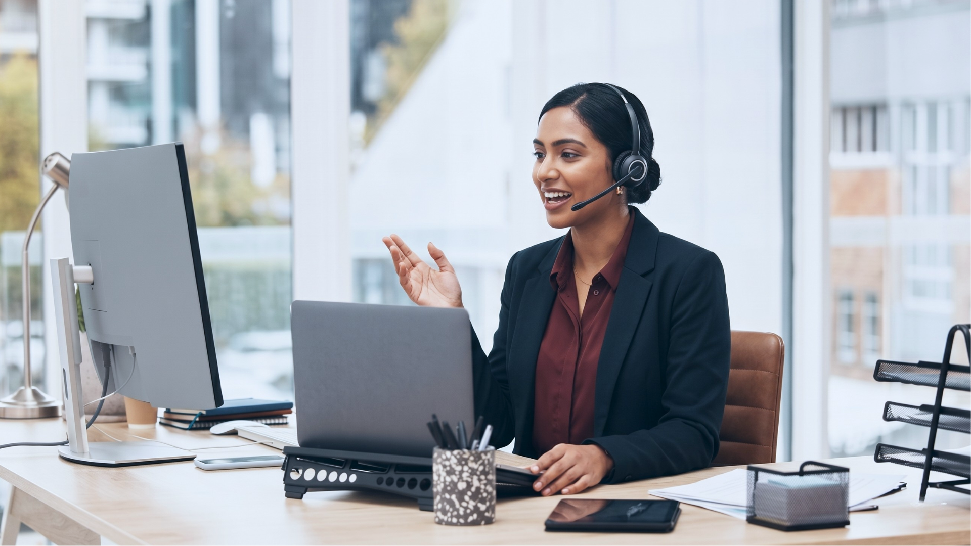 remote customer success manager answering client call in an office