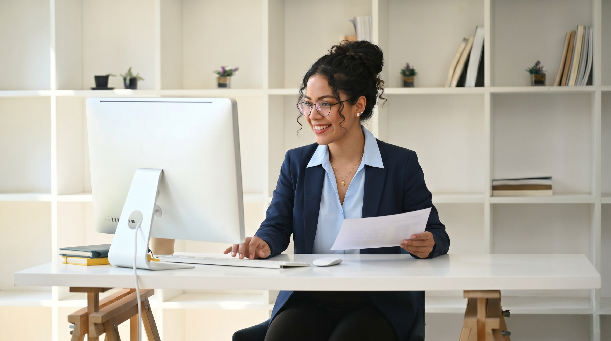 remote cost accountant reviewing financial documents at a desktop computer