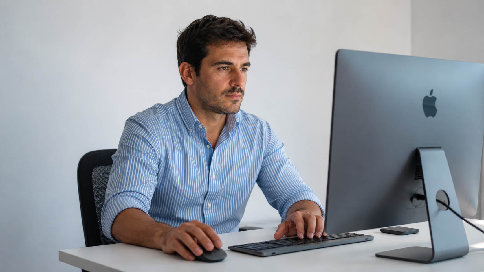 An offshore salesforce developer in Argentina focused on writing code on a desktop computer