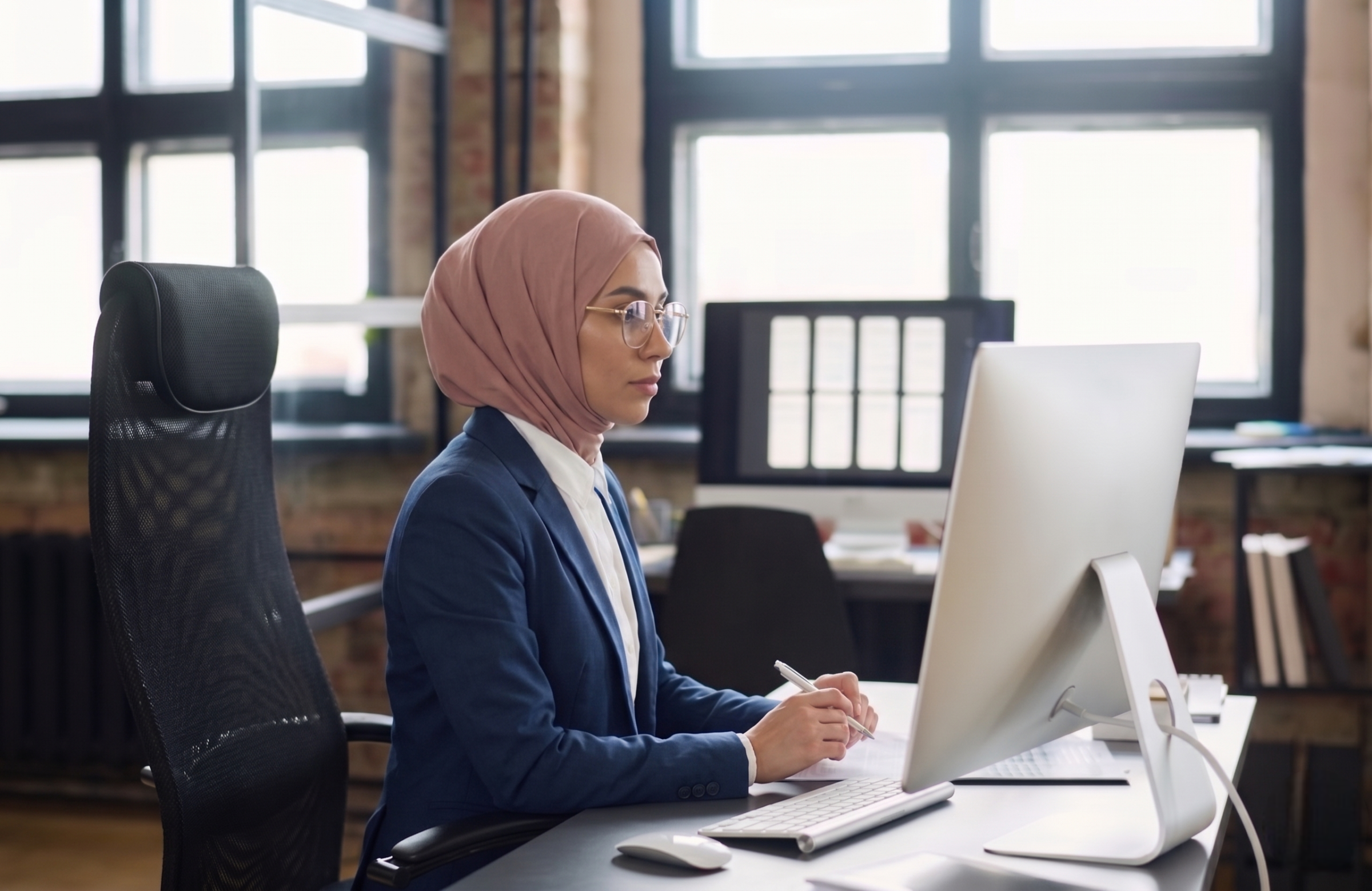 malaysian remote underwriter analyzing financial document in a computer