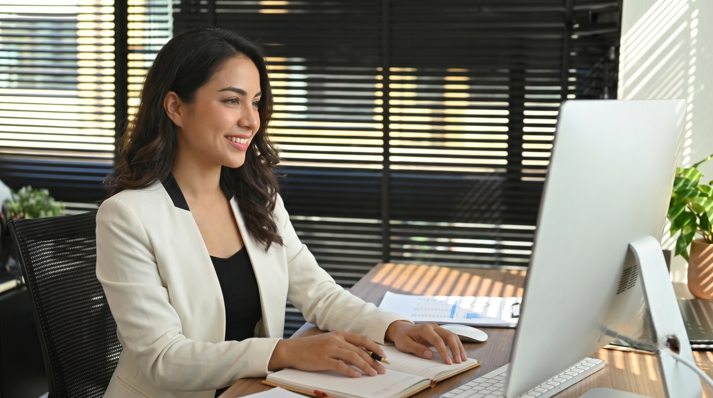 remote legal operations specialist smiling while working on a computer in Colombia