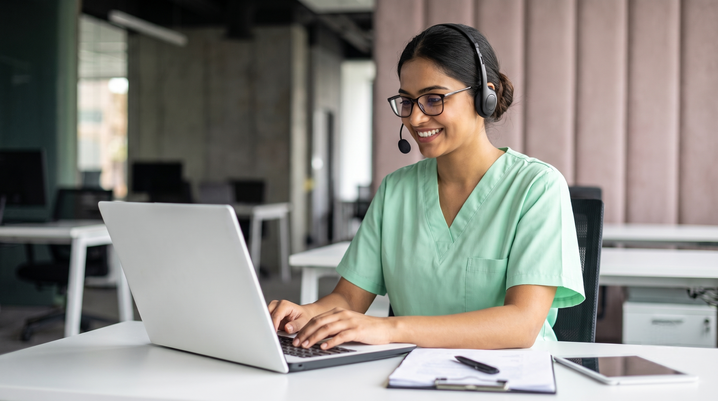 female clinical trial coordinator using a computer in India, providing professional outsourcing clinical trial support