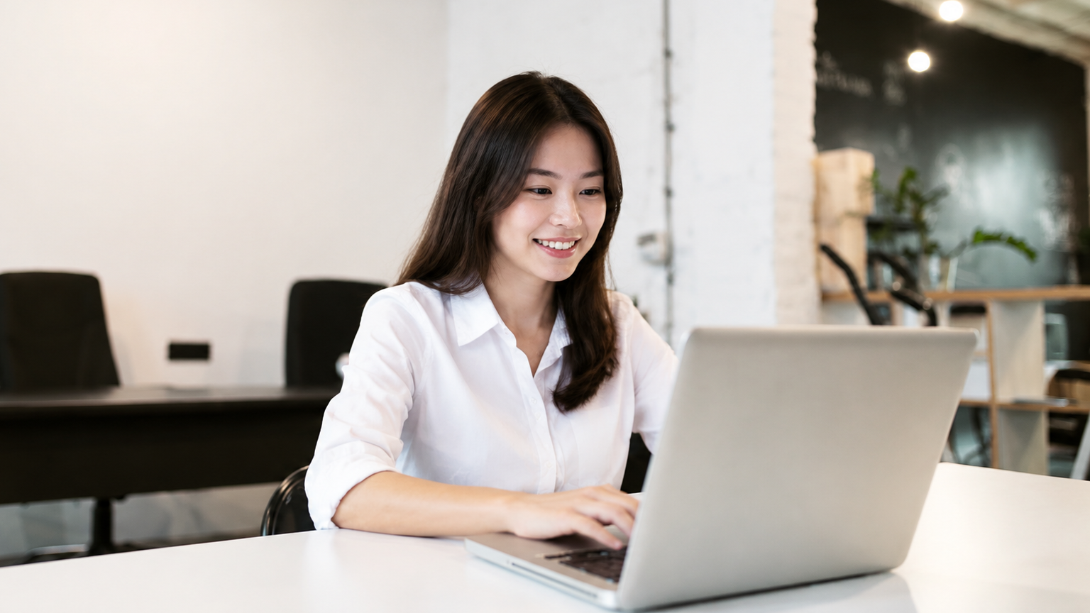 A female professional providing reliable offshore data entry services on a laptop
