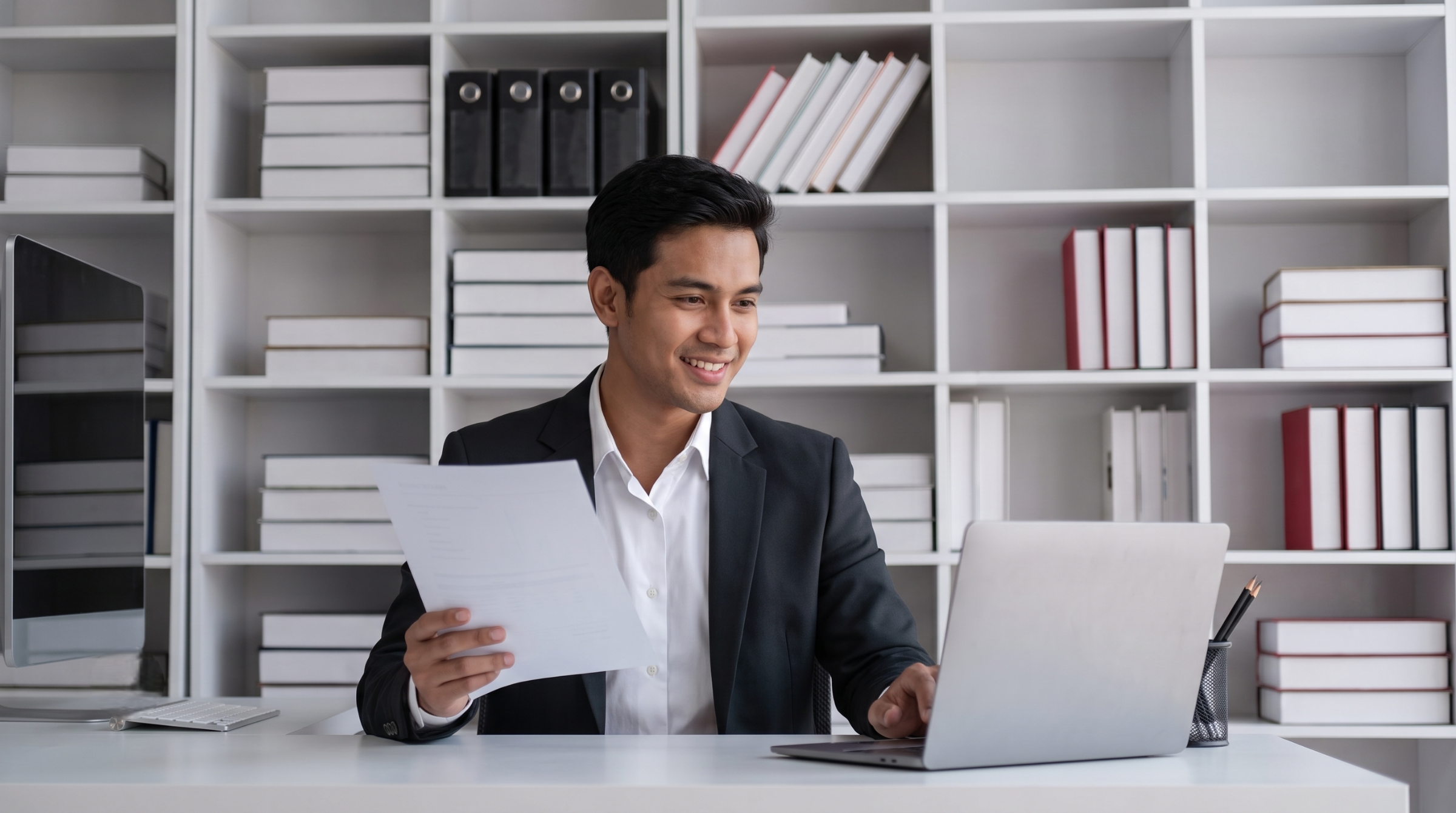 owner utilizes hr administration outsourcing services to review complex payroll and benefits documents at his desk