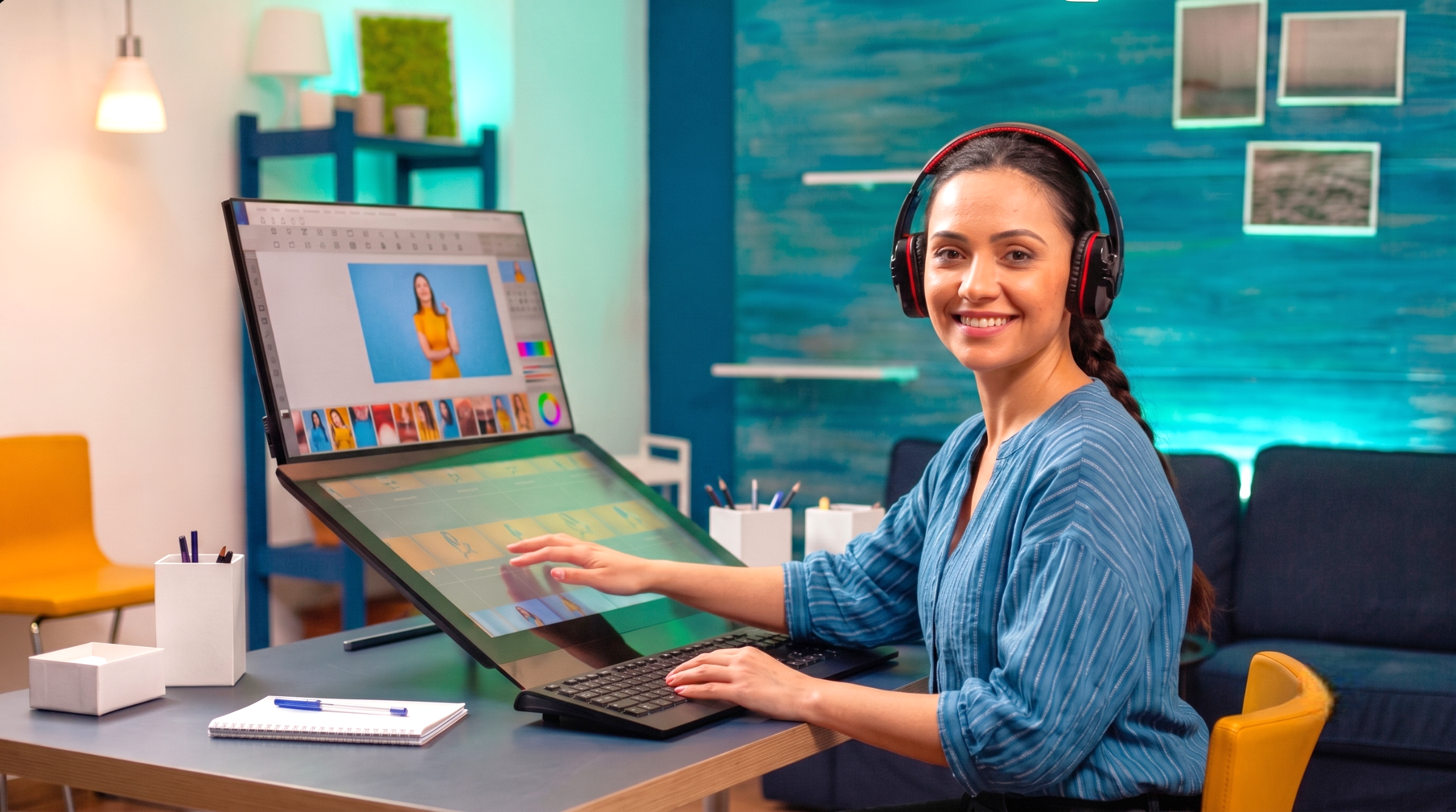 A remote image editor in India using a dual-screen touch monitor and headphones to retouch photos