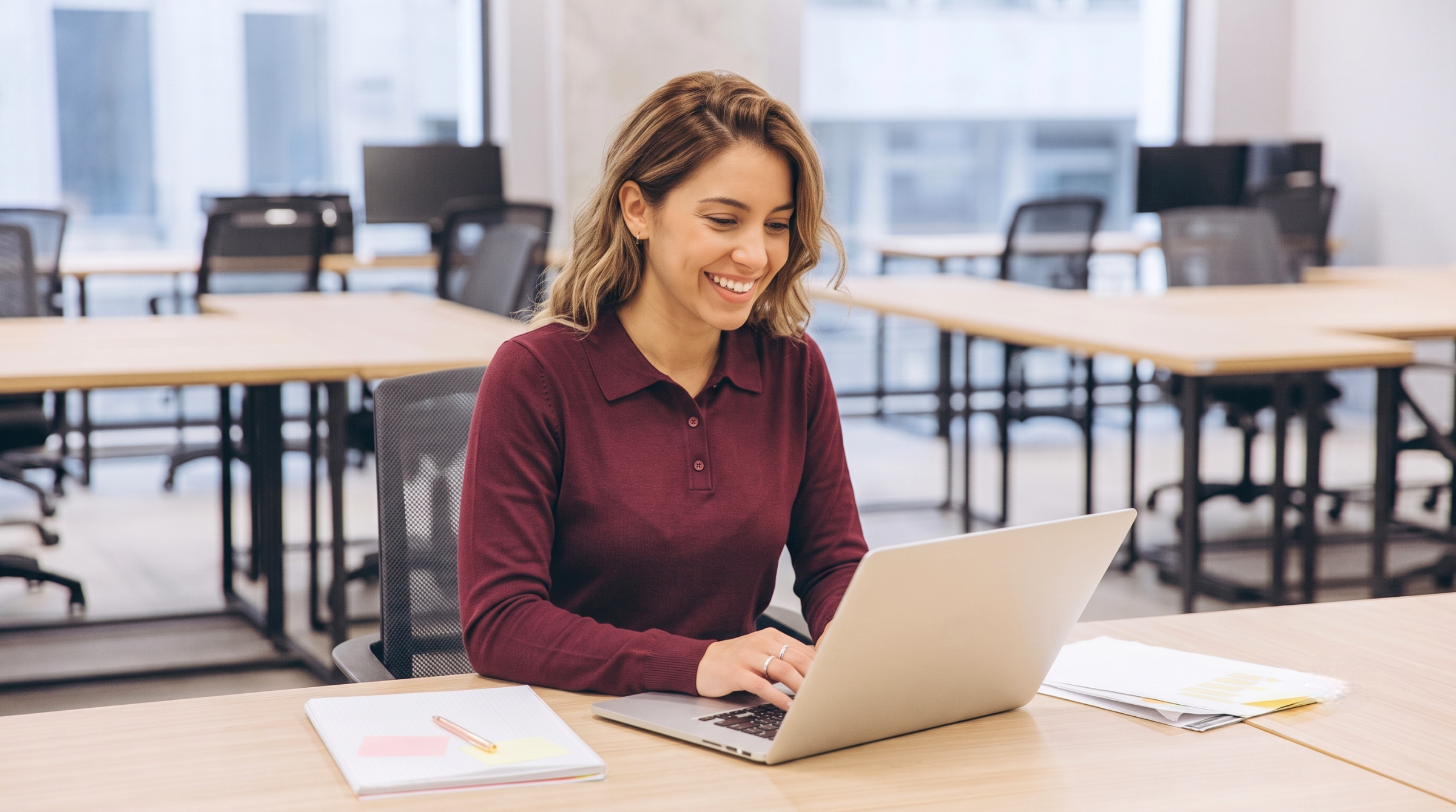 remote demand planner in argentina expert working with a laptop in an open concept office