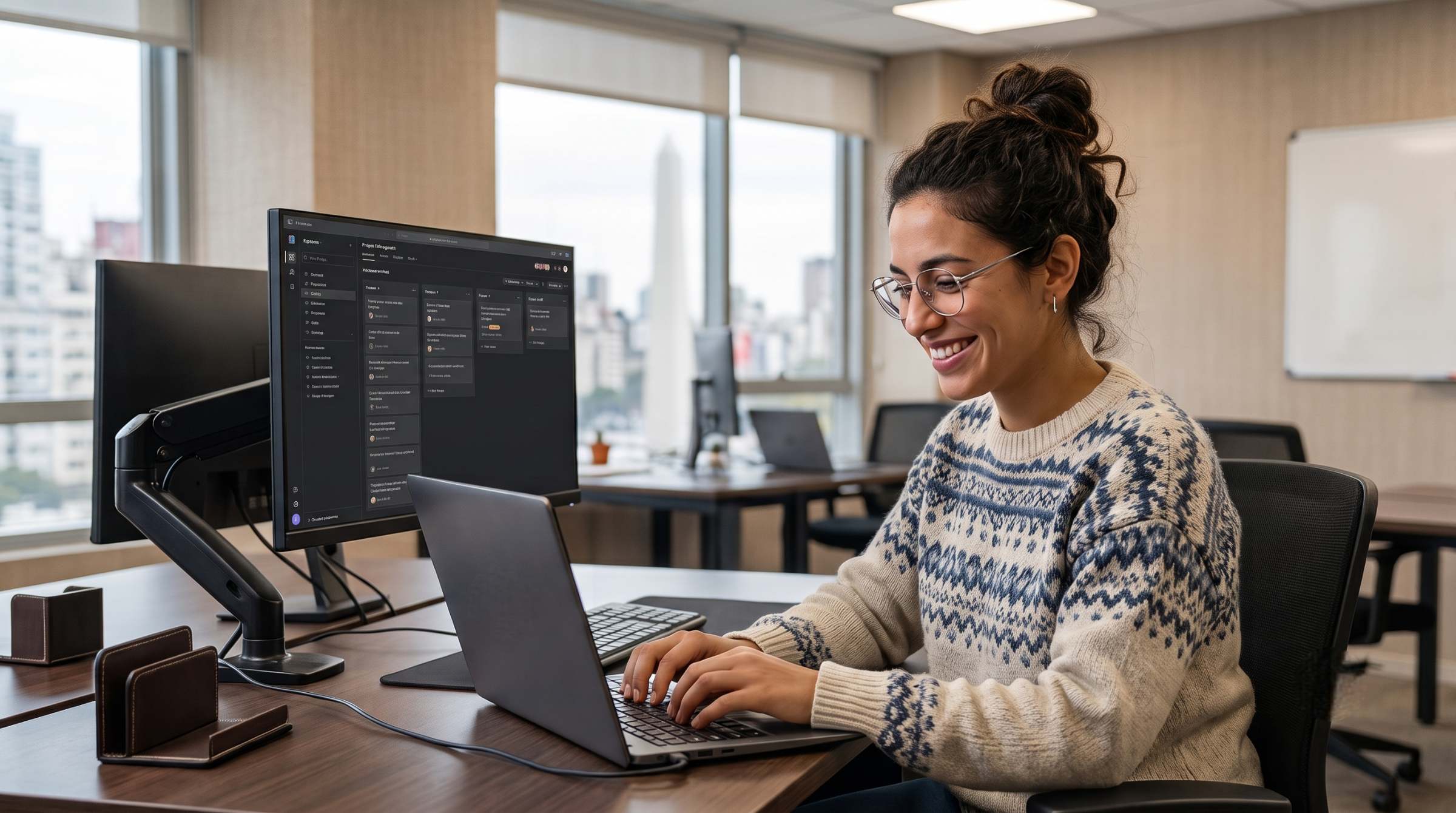 Professional cyber security engineer remote typing on laptop near dual-monitor workstation