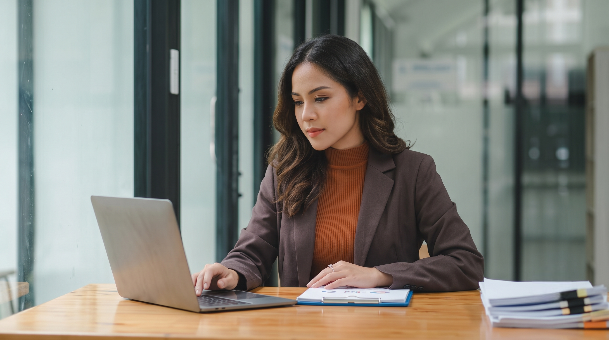 offshore financial accountant examining data spreadsheets on a laptop in a bright office space