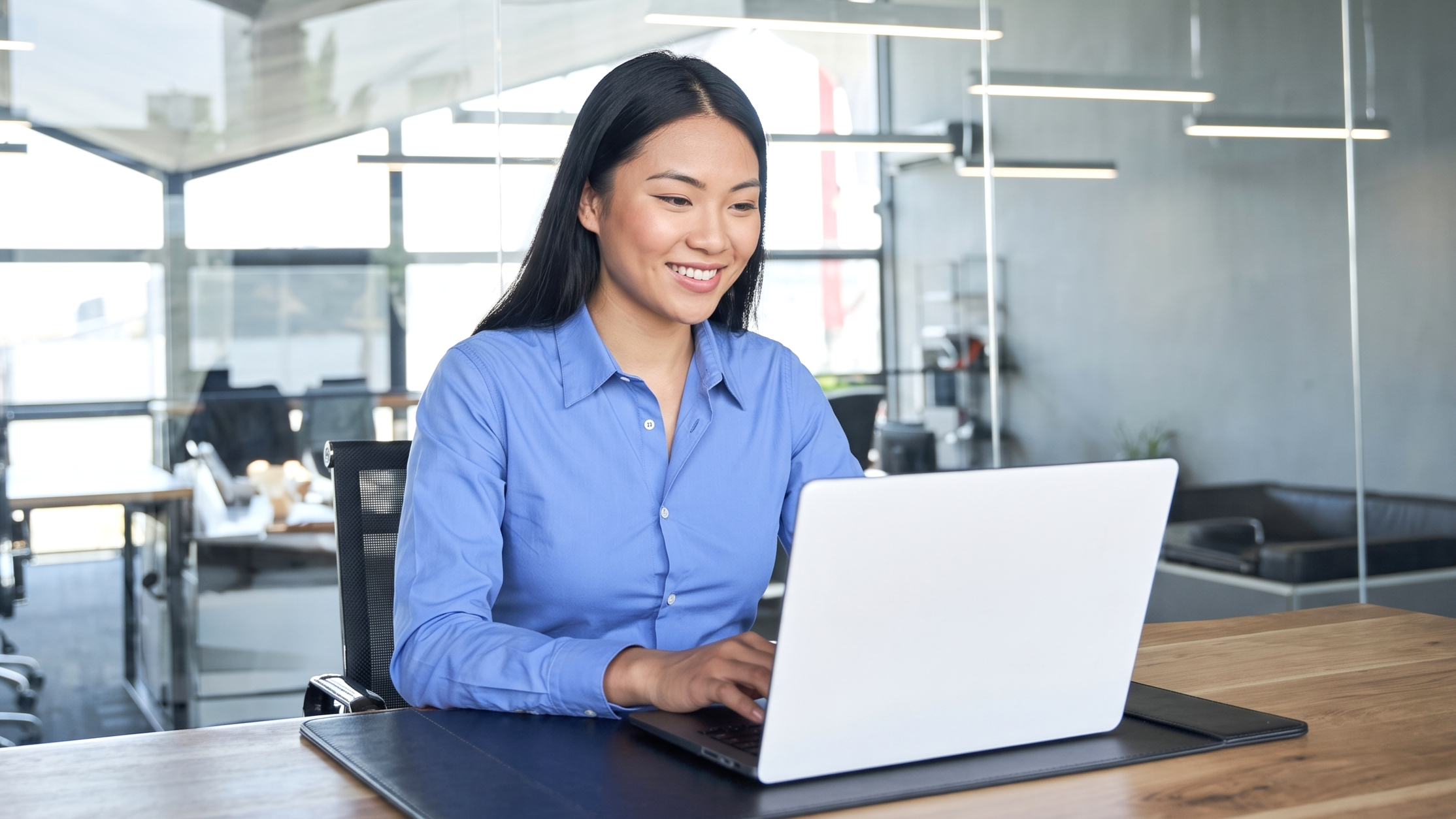 Remote asset management professional in Vietnam working on a laptop
