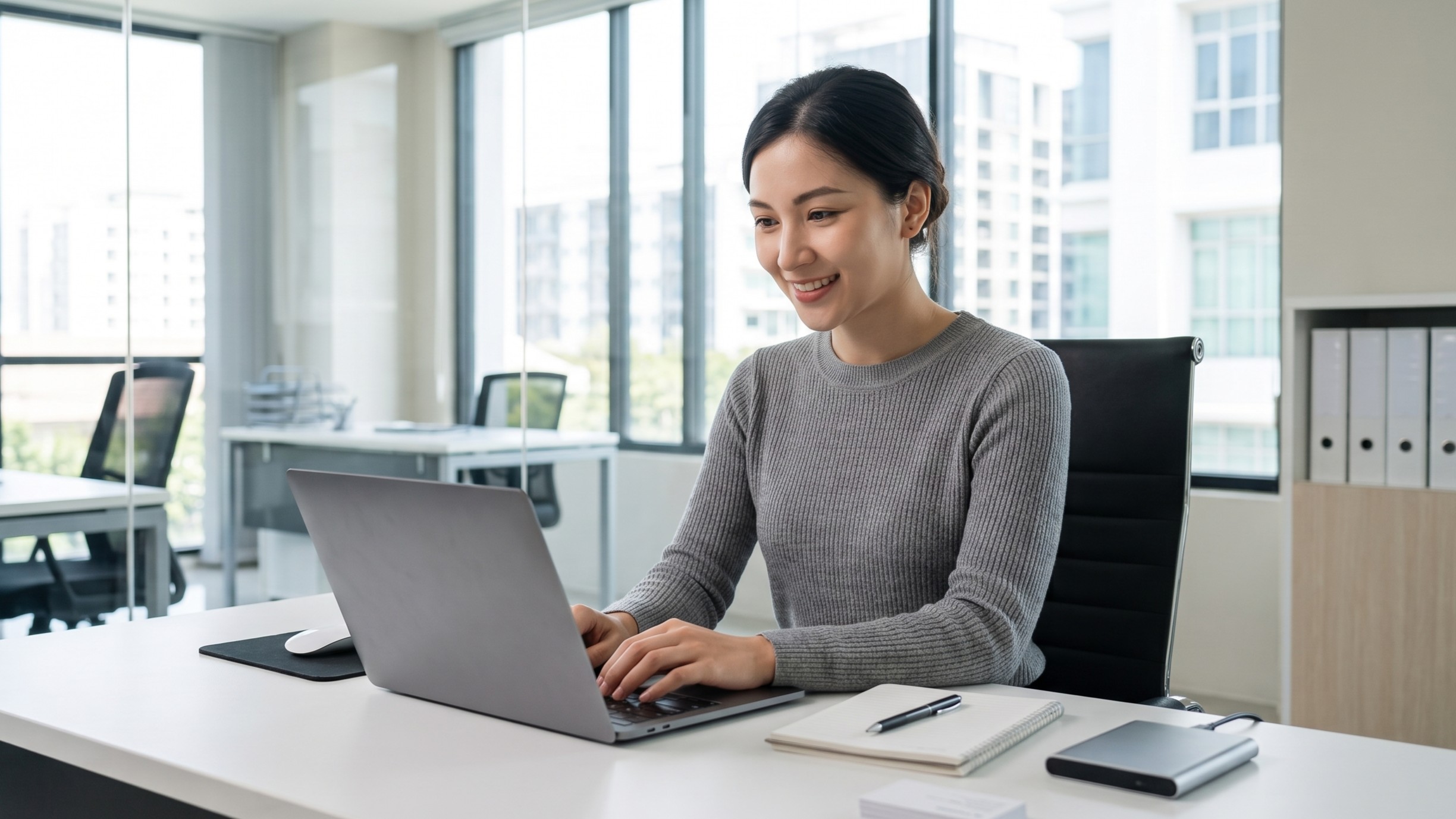 Inventory control expert managing records on a laptop