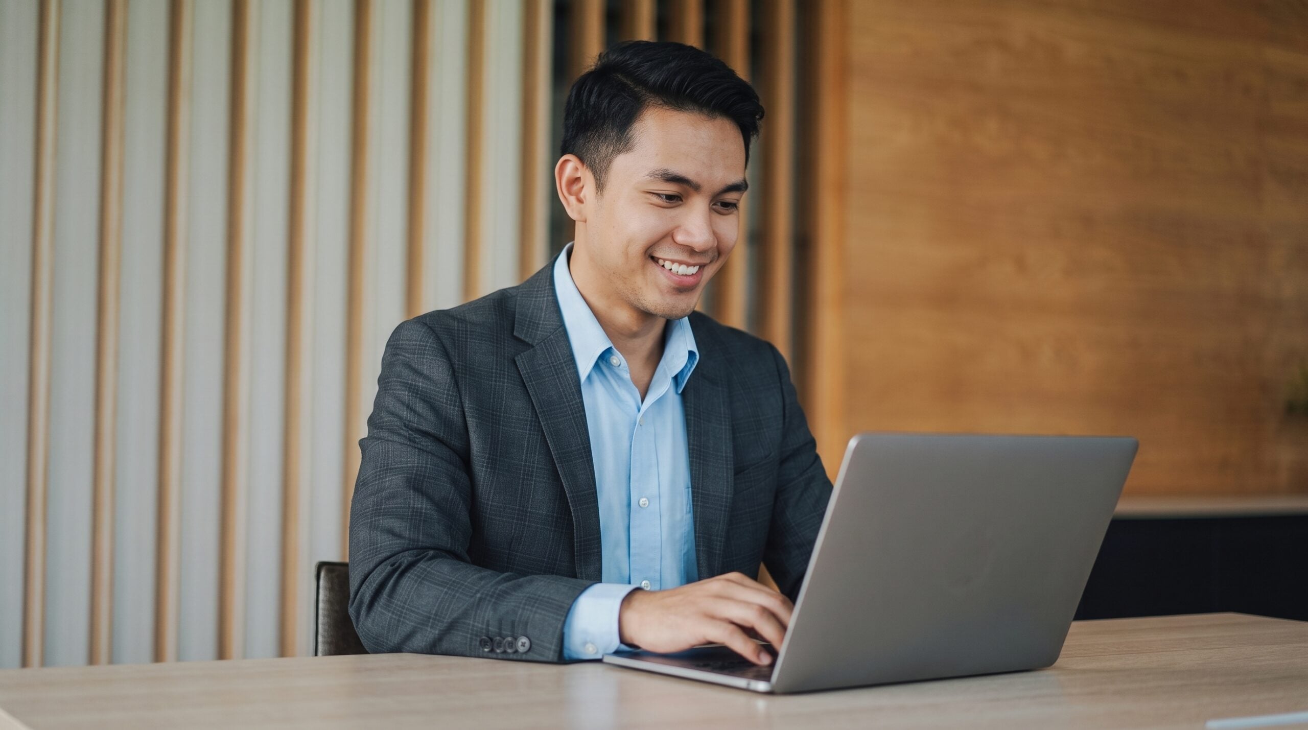 Remote management accountant in Malaysia working on financial reports at an organized workspace