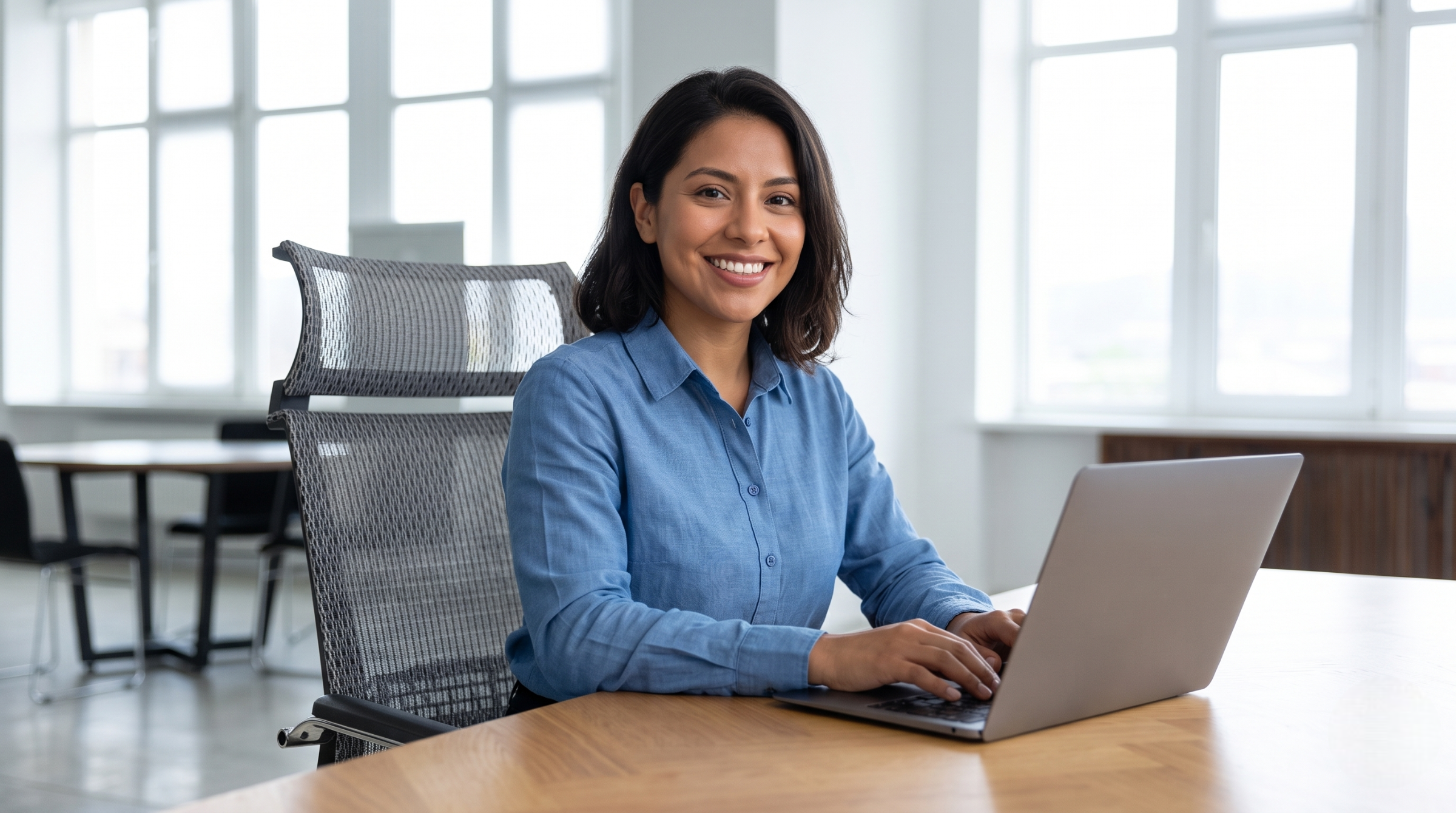 remote scrum master working on a laptop in a modern office setup