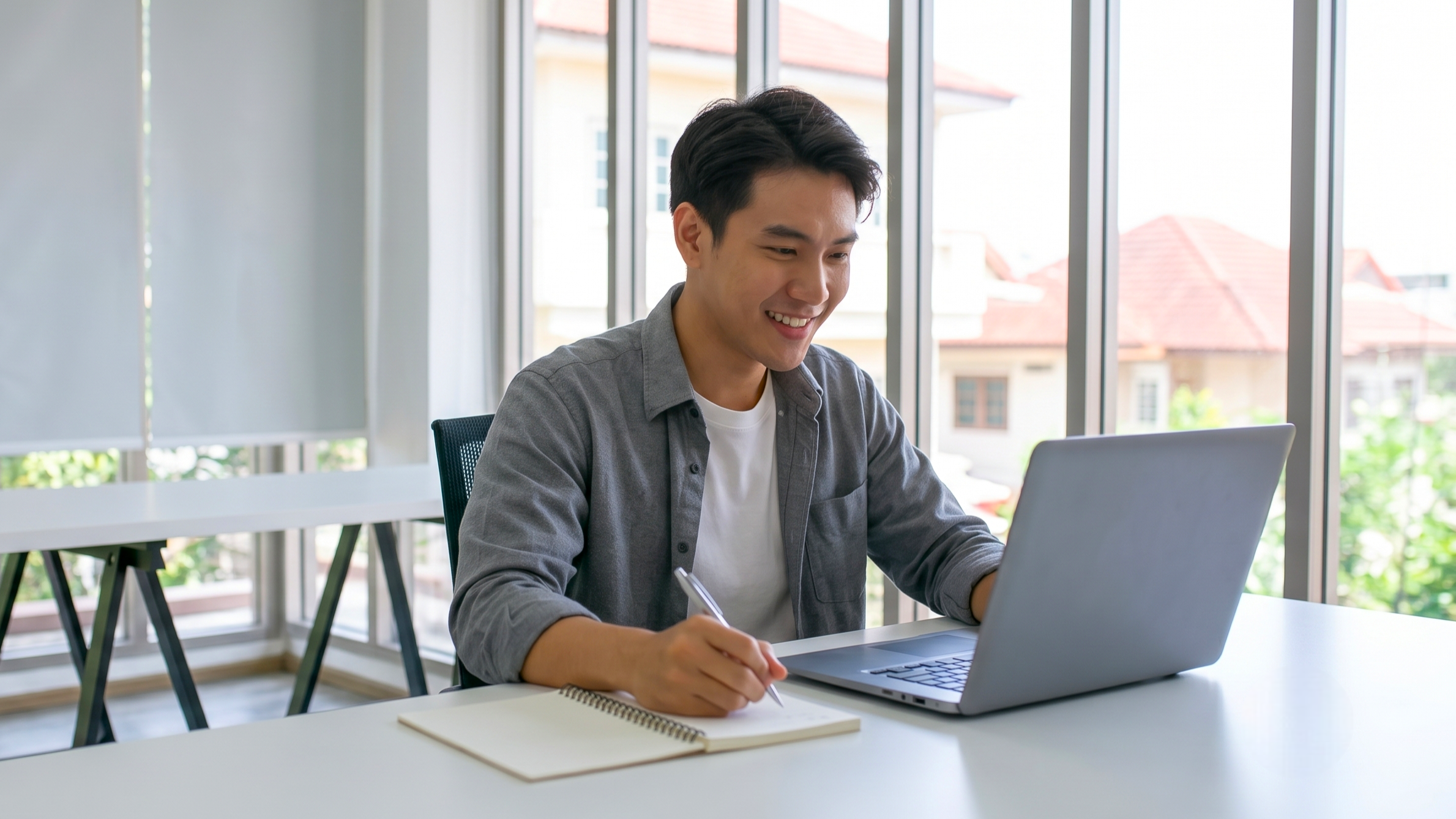 Man smiling while writing, demonstrating personal lifestyle assistant services