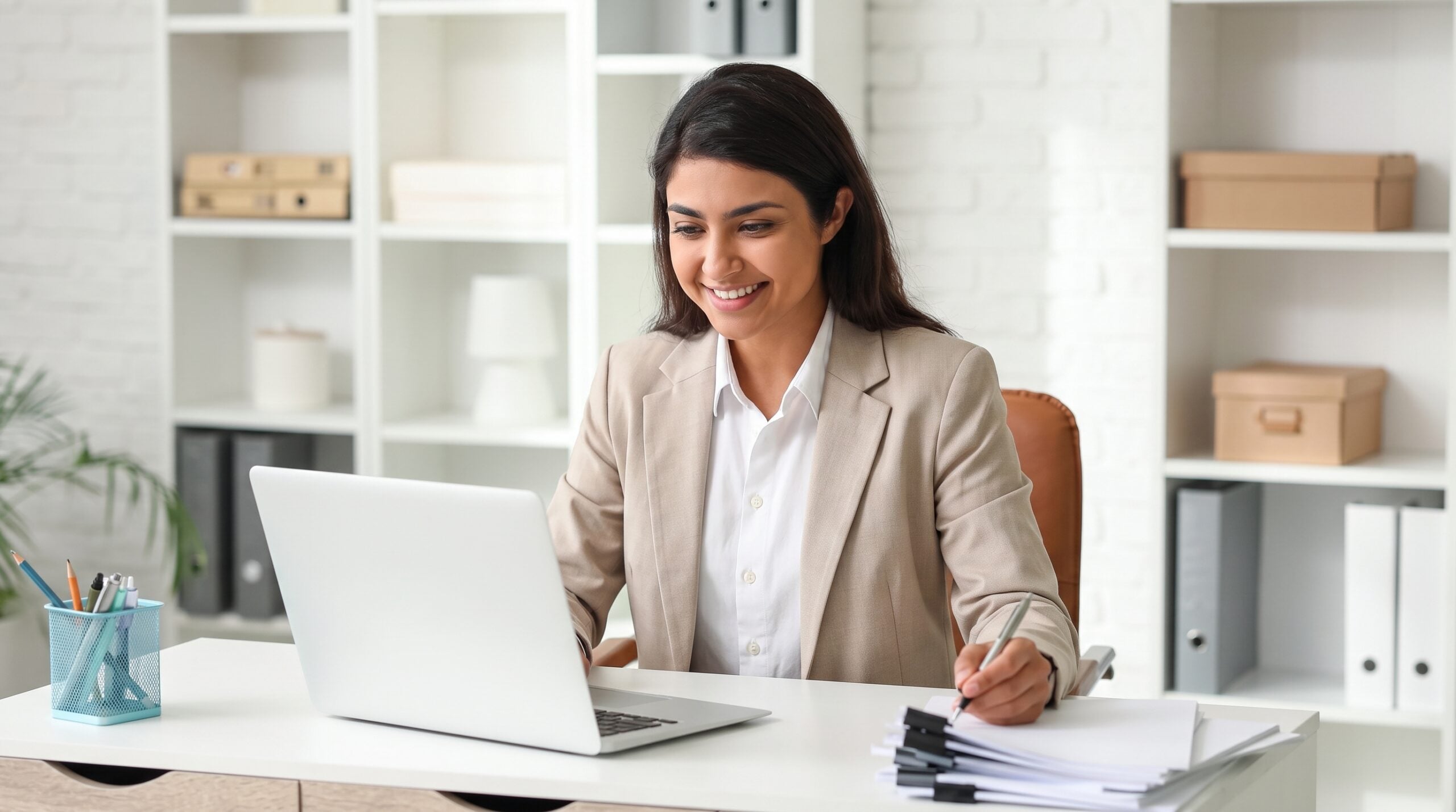 Outsourced credit control officer in India reviewing accounts on a laptop